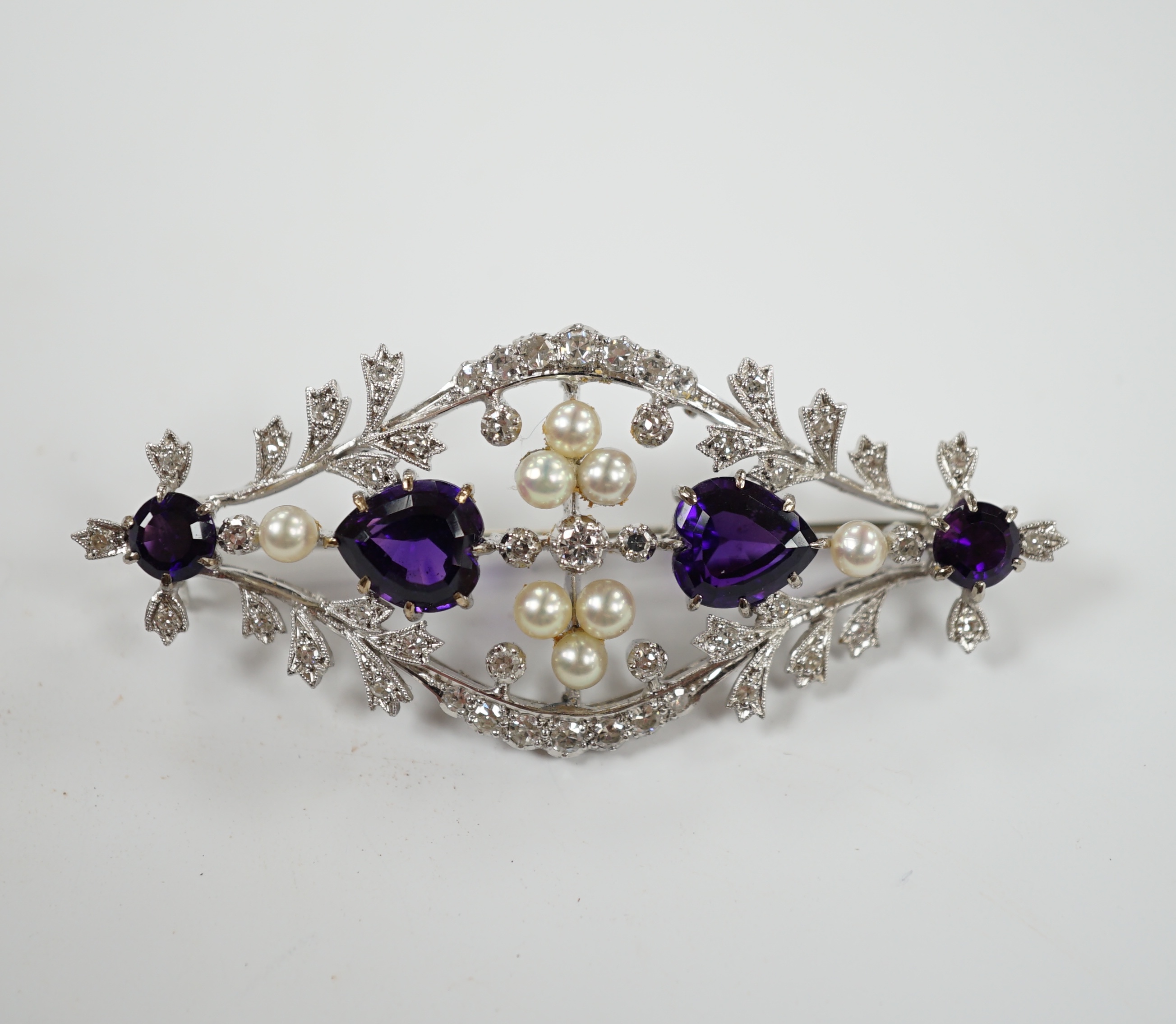 A white metal, diamond, cultured pearl and amethyst cluster set openwork brooch, 62mm, gross weight 16 grams.